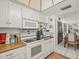 Functional kitchen with white cabinetry, laminate countertops, and modern appliances at 555 Gulf Way # 7N, St Pete Beach, FL 33706