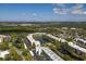 Aerial view of condominium community, showcasing lake, mature landscaping and parking at 6070 80Th N St # 410, St Petersburg, FL 33709