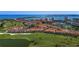 Beautiful aerial view of a golf course community with ponds and expansive ocean views at 6109 Mirada Cir, St Petersburg, FL 33715