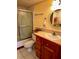 Bathroom with a shower/tub combo, vanity, and patterned glass shower door at 7040 Cognac Dr # 1, New Port Richey, FL 34653