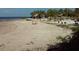 Sandy beach with sunbathers and swaying palms, creating a relaxing coastal ambiance at 7040 Cognac Dr # 1, New Port Richey, FL 34653