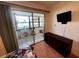 Bedroom with a bonus lanai, providing natural light, and a dresser for all your storage needs at 7040 Cognac Dr # 1, New Port Richey, FL 34653