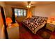 Bright bedroom featuring a decorative quilt, ceiling fan, and ample natural light at 7040 Cognac Dr # 1, New Port Richey, FL 34653