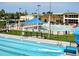 Large community pool featuring multiple swimming areas, including slides and shaded seating at 7040 Cognac Dr # 1, New Port Richey, FL 34653