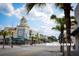 View of downtown street lined with buildings and palm trees under a bright sky at 7040 Cognac Dr # 1, New Port Richey, FL 34653