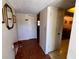 Foyer with wood-look flooring, decorative mirrors, and access to multiple rooms at 7040 Cognac Dr # 1, New Port Richey, FL 34653