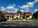 Inviting townhome showcasing a well-manicured lawn and parking spaces on a bright, sunny day at 7040 Cognac Dr # 1, New Port Richey, FL 34653