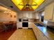 Charming kitchen with white cabinets, essential appliances, and an open view to the dining area at 7040 Cognac Dr # 1, New Port Richey, FL 34653