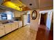 Cozy kitchen with white cabinets, appliances, and a unique ceiling fan feature at 7040 Cognac Dr # 1, New Port Richey, FL 34653