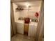 Functional laundry room with a washer and dryer, including storage shelves and a folding rack at 7040 Cognac Dr # 1, New Port Richey, FL 34653