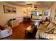 Relaxing living room area with hardwood floors, cozy seating, and connection to the kitchen at 7040 Cognac Dr # 1, New Port Richey, FL 34653