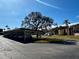 Community carport area with mature shade trees and additional parking, near beautifully maintained townhomes at 7040 Cognac Dr # 1, New Port Richey, FL 34653