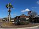 Entrance to Magnolia Valley Condominiums with sign, landscaping, and American flag at 7040 Cognac Dr # 1, New Port Richey, FL 34653