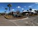 Entrance to Magnolia Valley Condominiums with sign, landscaping, and American flag at 7040 Cognac Dr # 1, New Port Richey, FL 34653