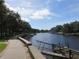 Picturesque waterfront view with docks and a scenic walking path lined with lush trees at 7040 Cognac Dr # 1, New Port Richey, FL 34653