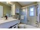 Bathroom featuring white cabinetry, shower-tub combo, tile backsplash, and dark hardware at 7148 Jenner Ave, New Port Richey, FL 34655