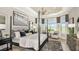 Bright bedroom features a four-poster bed, large windows, and decorative seating area at 8092 Moonbeam Ave, Sarasota, FL 34241