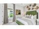 Comfortable bedroom with a striking green velvet headboard and decorative wall art at 8092 Moonbeam Ave, Sarasota, FL 34241