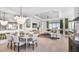 Elegant dining room with a modern chandelier, connecting to the open-concept living room and kitchen at 8092 Moonbeam Ave, Sarasota, FL 34241