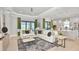 Open concept living room features tile floors, neutral tones, and sliding glass doors to the lanai at 8092 Moonbeam Ave, Sarasota, FL 34241