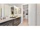Bright main bathroom with double vanity, granite countertops, and a view of the walk-in closet at 8092 Moonbeam Ave, Sarasota, FL 34241