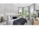 Well-lit main bedroom featuring neutral decor, decorative wallpaper, three windows, and a walk-in closet at 8092 Moonbeam Ave, Sarasota, FL 34241
