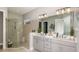 Modern bathroom with a double vanity, walk-in shower, and neutral color palette at 8100 Moonbeam Ave, Sarasota, FL 34241