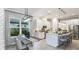 Bright kitchen and dining area with stainless steel appliances, an island, and pendant lighting at 8100 Moonbeam Ave, Sarasota, FL 34241