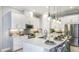 Modern kitchen featuring stainless steel appliances, an island with seating, and pendant lighting at 8100 Moonbeam Ave, Sarasota, FL 34241