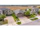 A high angle shot shows a well landscaped property, a paved driveway, and an American flag at 10019 Celtic Ash Dr, Ruskin, FL 33573