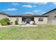 Expansive backyard showing a covered patio with dining set on a well-maintained lawn at 10019 Celtic Ash Dr, Ruskin, FL 33573