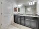 Bathroom featuring dual sinks with granite countertops and a tiled floor at 10019 Celtic Ash Dr, Ruskin, FL 33573