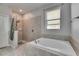 Bathroom with separate soaking tub and tiled walk-in shower at 10019 Celtic Ash Dr, Ruskin, FL 33573