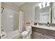 Clean bathroom featuring a shower-tub combo, modern vanity with granite countertop, and neutral color scheme at 10019 Celtic Ash Dr, Ruskin, FL 33573