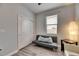 Bedroom area with a gray sofa, natural lighting, and closet at 10019 Celtic Ash Dr, Ruskin, FL 33573