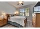 Cozy bedroom with a comfortable bed, a ceiling fan and nice natural light from the window at 10019 Celtic Ash Dr, Ruskin, FL 33573