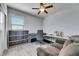 Neutral bedroom features sloped ceilings, a ceiling fan, and a built-in bookshelf at 10019 Celtic Ash Dr, Ruskin, FL 33573