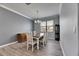 Bright dining room features neutral walls, wood floors, and a modern chandelier at 10019 Celtic Ash Dr, Ruskin, FL 33573