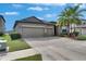 Charming single Gathering home showcasing a three-car garage, well-kept lawn, and beautiful palm trees at 10019 Celtic Ash Dr, Ruskin, FL 33573