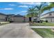 Charming single Gathering home showcasing a three-car garage, well-kept lawn, and beautiful palm trees at 10019 Celtic Ash Dr, Ruskin, FL 33573