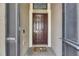 Inviting front entrance featuring a solid wood door, decorative welcome mat and storm door at 10019 Celtic Ash Dr, Ruskin, FL 33573