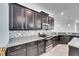 Kitchen featuring stainless steel appliances, dark cabinets, granite countertops, and mosaic backsplash at 10019 Celtic Ash Dr, Ruskin, FL 33573