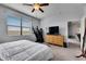 Inviting bedroom featuring a large window, natural light and modern gray plank flooring at 10019 Celtic Ash Dr, Ruskin, FL 33573