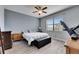 Spacious bedroom featuring a ceiling fan, large window and modern gray plank flooring at 10019 Celtic Ash Dr, Ruskin, FL 33573