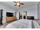 Large bedroom showcases connecting bathroom, walk-in closet, and modern gray plank flooring at 10019 Celtic Ash Dr, Ruskin, FL 33573