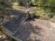 An aerial view shows the roof of a yellow house with mature trees and sunny skies at 10171 Patrick St, Brooksville, FL 34601