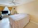 Bedroom featuring tile flooring, ceiling fan, and a large window for natural light at 10346 Carrollwood Ln # 171, Tampa, FL 33618