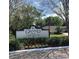 Elegant community sign amidst beautiful landscaping and flowering plants at 10346 Carrollwood Ln # 171, Tampa, FL 33618