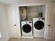 A laundry closet featuring a stacked washer and dryer with shelving above them at 10346 Carrollwood Ln # 171, Tampa, FL 33618