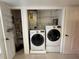 A laundry closet featuring a stacked washer and dryer with shelving above them at 10346 Carrollwood Ln # 171, Tampa, FL 33618